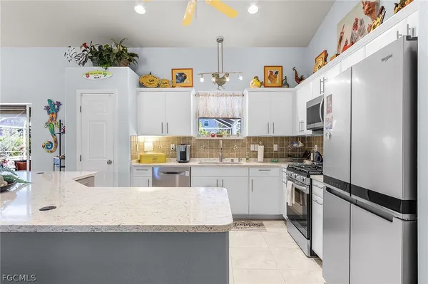 a kitchen with refrigerator and window