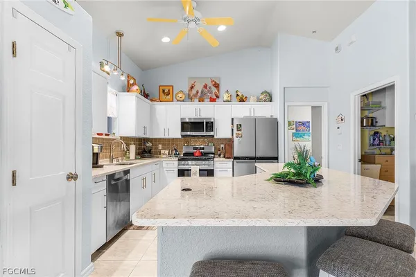 a kitchen with granite countertop cabinets and refrigerator