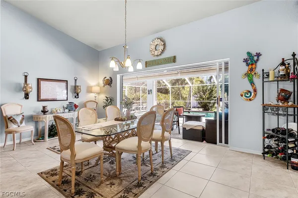 a dining room filled with furniture and large windows