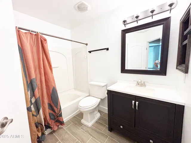 a bathroom with a sink toilet a mirror and shower