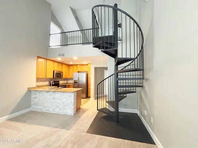 a view of staircase with wooden floor and a potted plant