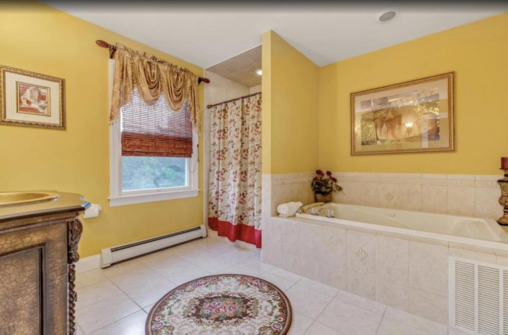 2655 Rocky Point Road East Marion, NY 11939 - Photo 11 of 23 Full bath featuring a bath, visible vents, tile patterned flooring, baseboard heating, and vanity