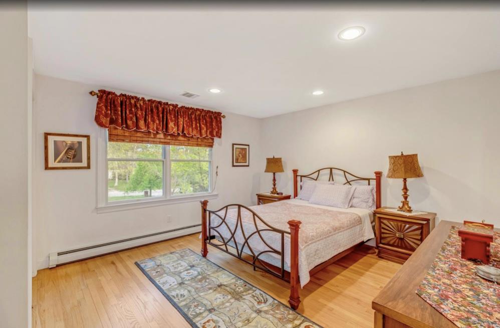 2655 Rocky Point Road East Marion, NY 11939 - Photo 13 of 23 Bedroom featuring recessed lighting, baseboard heating, light wood finished floors, and visible vents