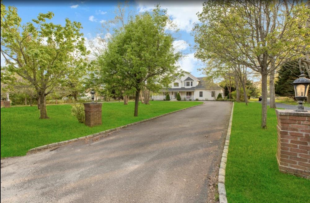 2655 Rocky Point Road East Marion, NY 11939 - Photo 20 of 23 Cape cod-style house featuring a front yard and aphalt driveway