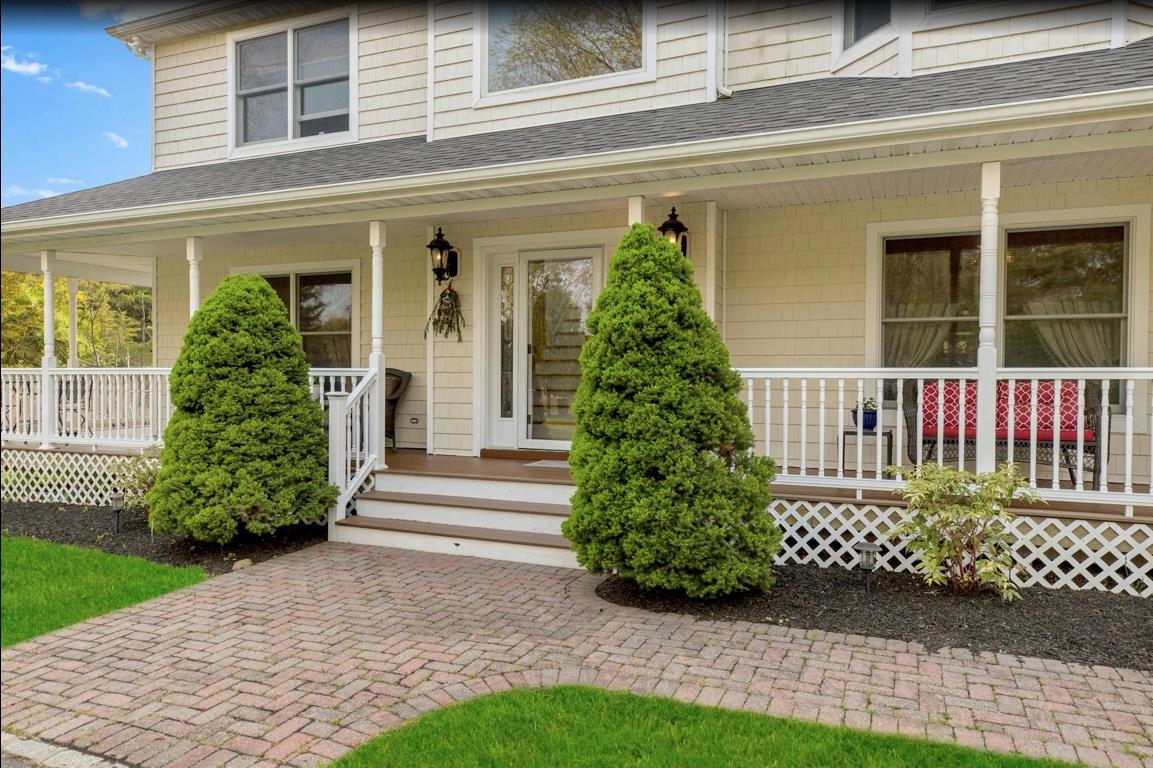 2655 Rocky Point Road East Marion, NY 11939 - Photo 2 of 23 View of exterior entry featuring a porch and a shingled roof