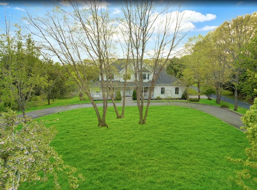 2655 Rocky Point Road East Marion, NY 11939 - Photo 23 of 23 Cape cod house featuring curved driveway and a front yard