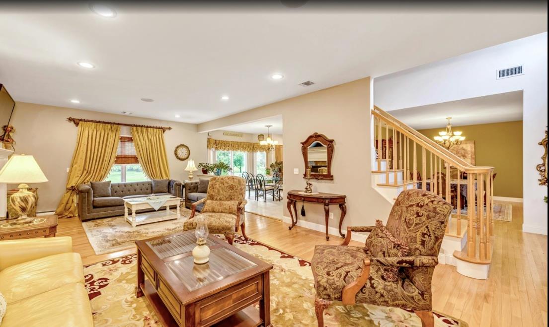 2655 Rocky Point Road East Marion, NY 11939 - Photo 5 of 23 Living area with visible vents, wood finished floors, and a notable chandelier