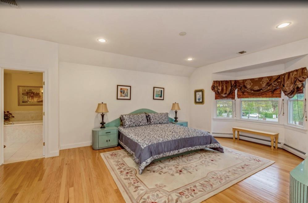 2655 Rocky Point Road East Marion, NY 11939 - Photo 9 of 23 Bedroom featuring recessed lighting, lofted ceiling, light wood-type flooring, and visible vents