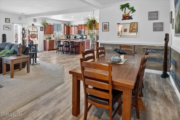 a dining room with furniture and wooden floor