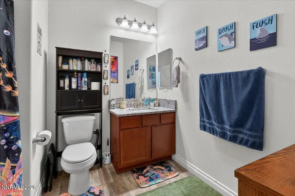 a bathroom with a toilet a sink and shower
