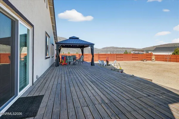 a view of a balcony with wooden floor and outdoor seating