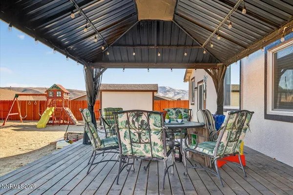a view of deck with table and chairs and wooden floor