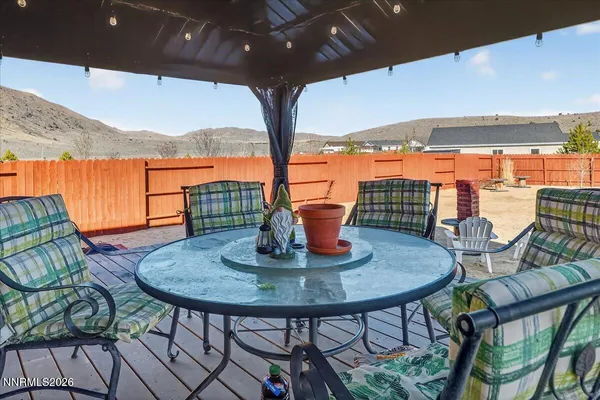 a view of balcony with table and chairs