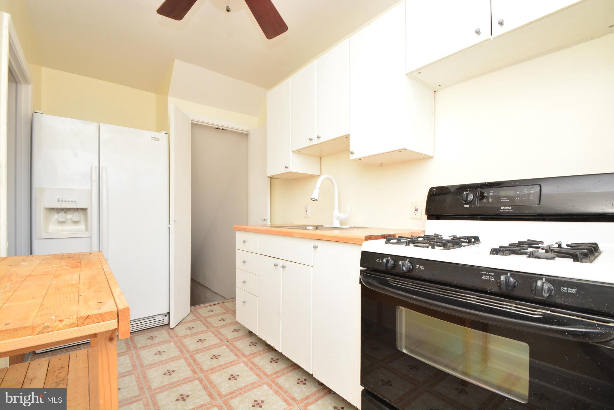 2859 Plainfield Road Dundalk, MD 21222 - Photo 11 of 24 a kitchen with a sink appliances and cabinets