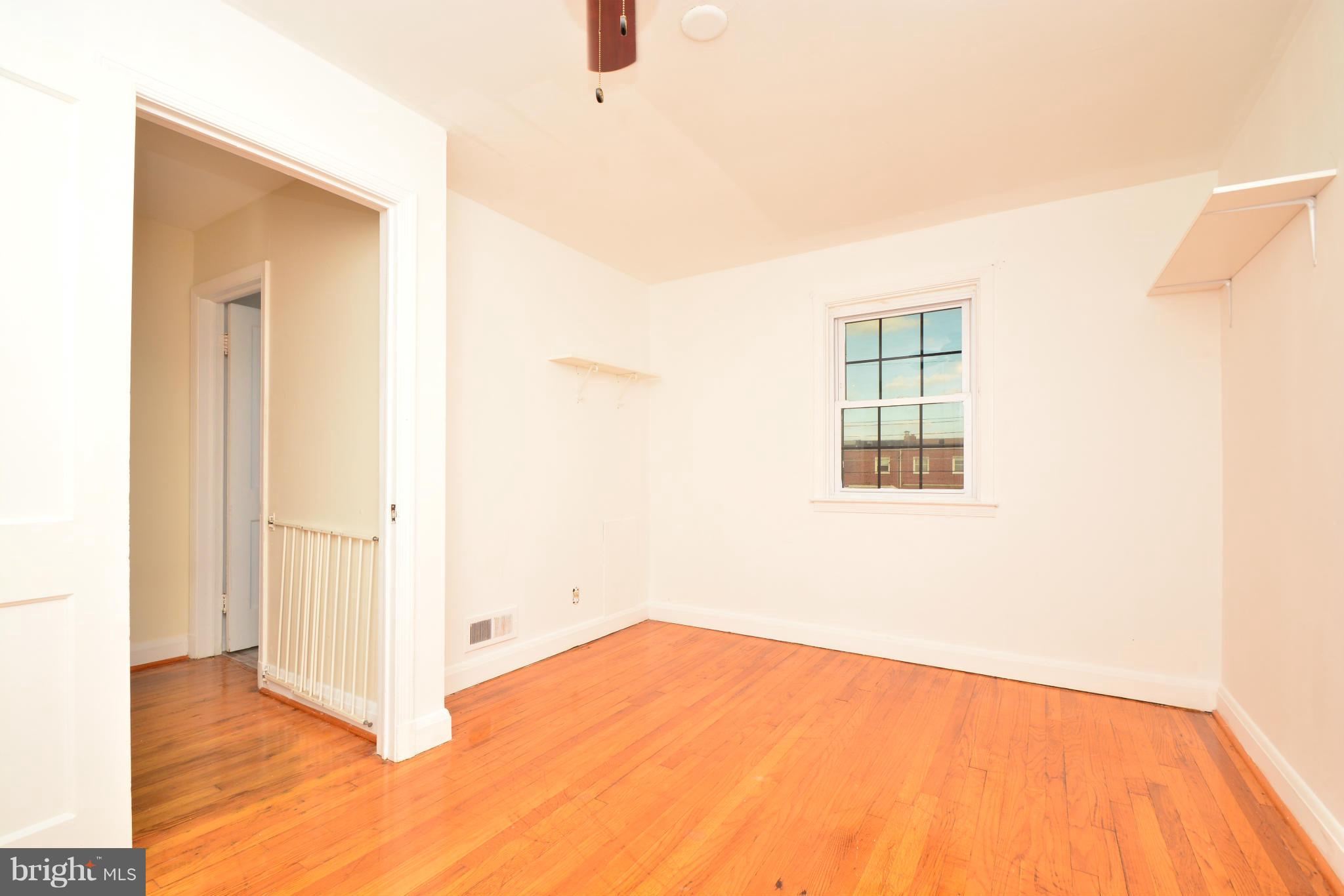 2859 Plainfield Road Dundalk, MD 21222 - Photo 15 of 24 a view of empty room with wooden floor and fan