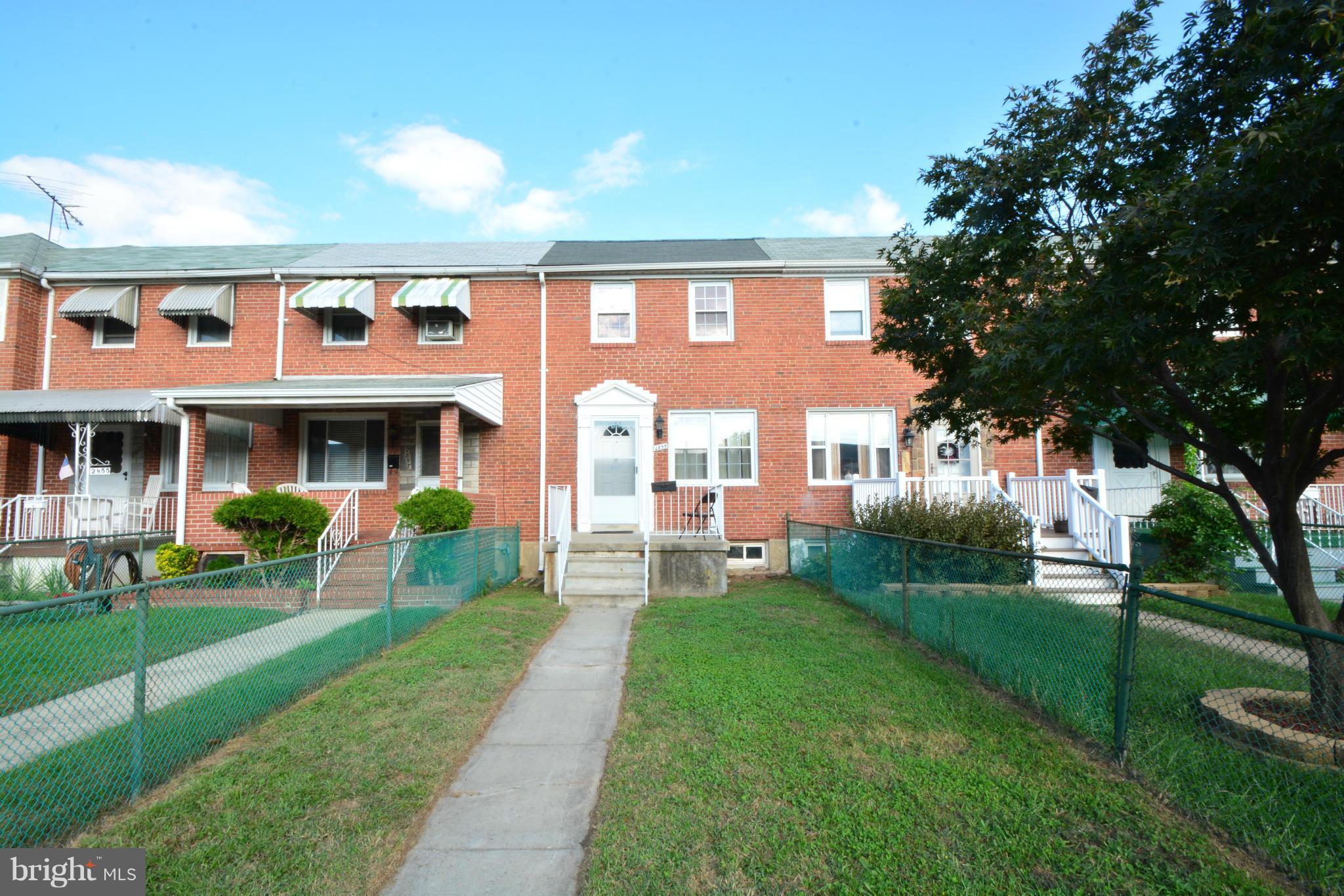 2859 Plainfield Road Dundalk, MD 21222 - Photo 2 of 24 a front view of a house with a yard table and chairs