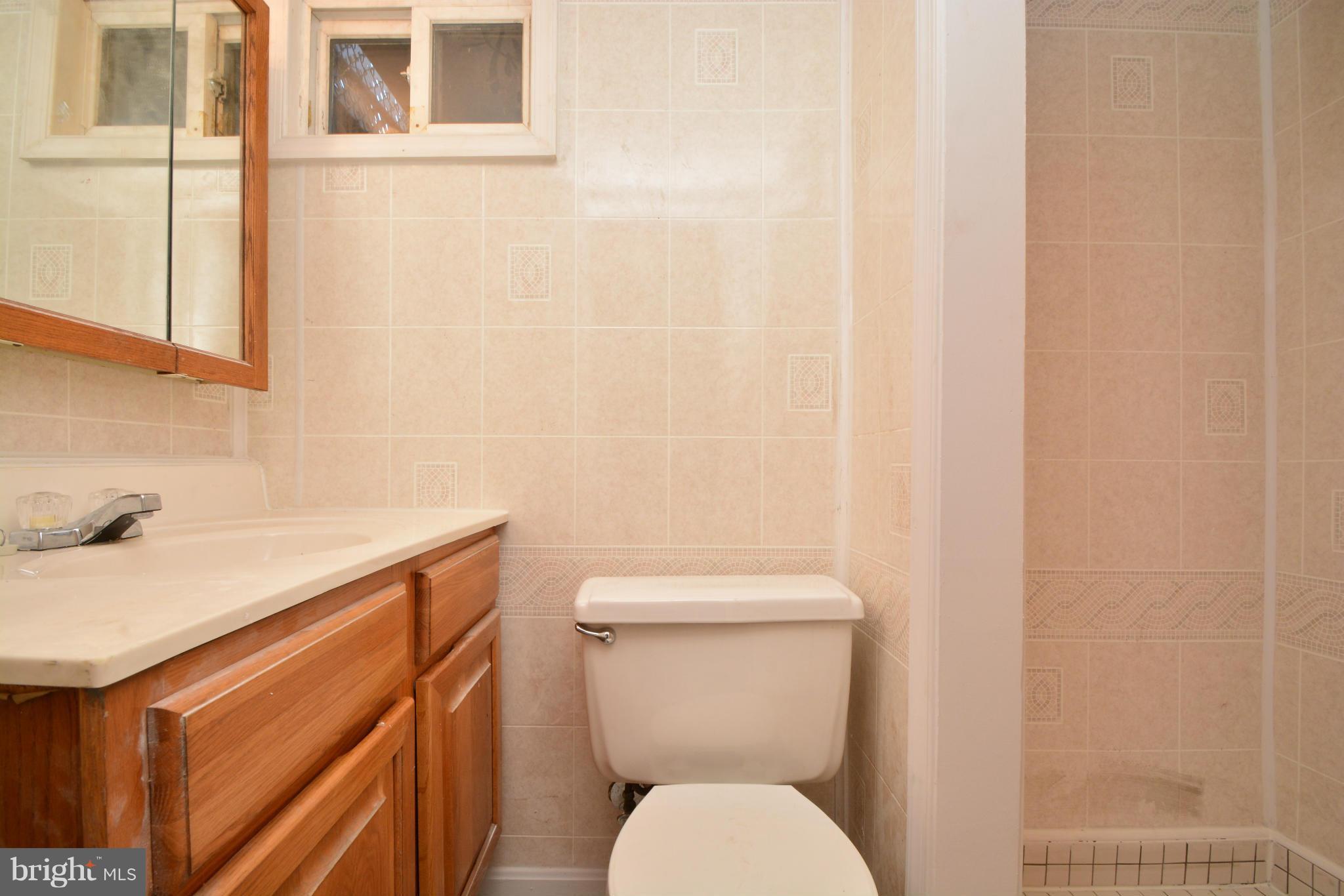 2859 Plainfield Road Dundalk, MD 21222 - Photo 22 of 24 a white toilet sitting next to a bathroom sink