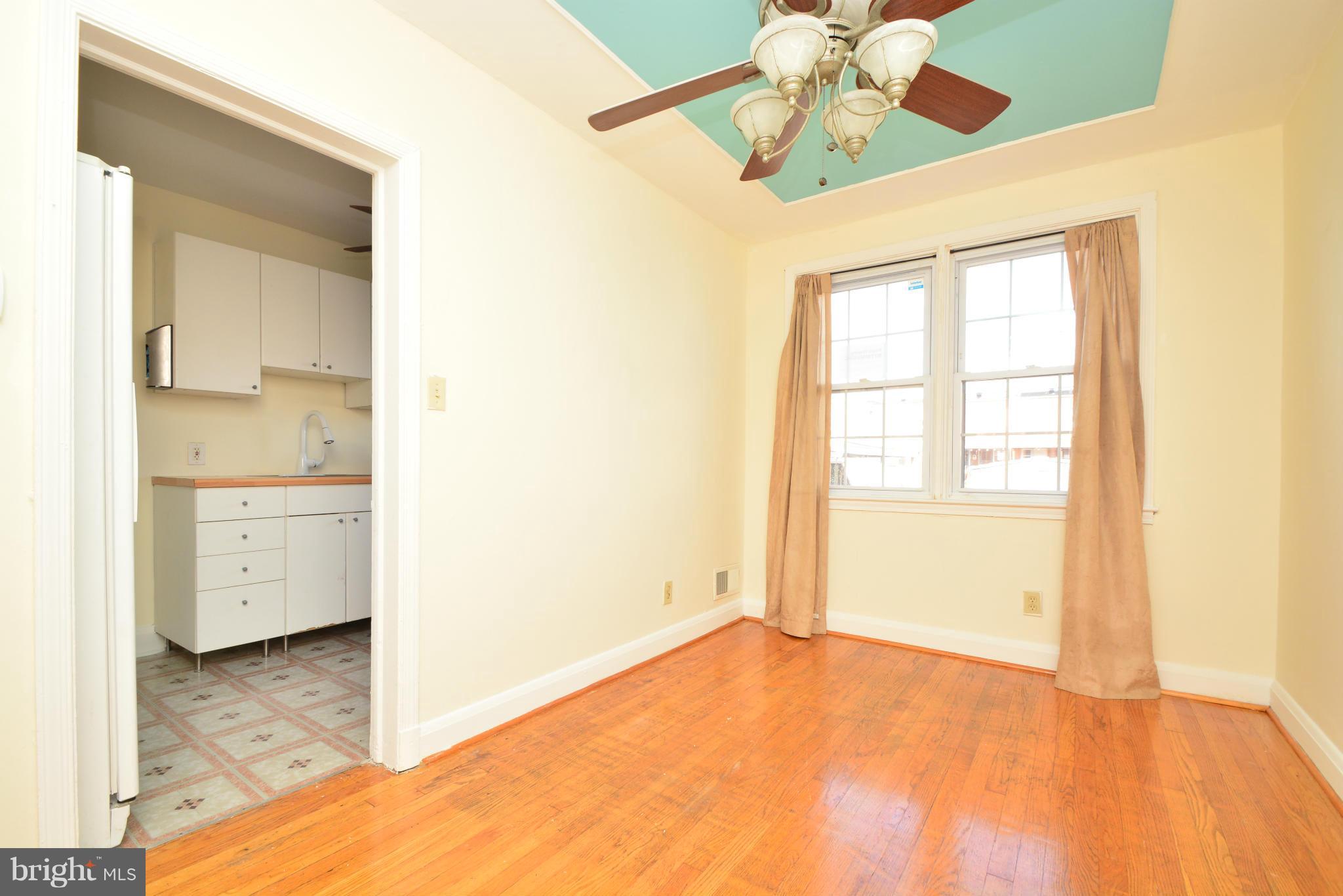 2859 Plainfield Road Dundalk, MD 21222 - Photo 7 of 24 a view of an empty room with window and a kitchen