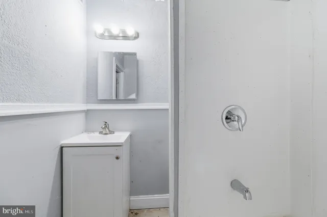 a bathroom with a sink and mirror