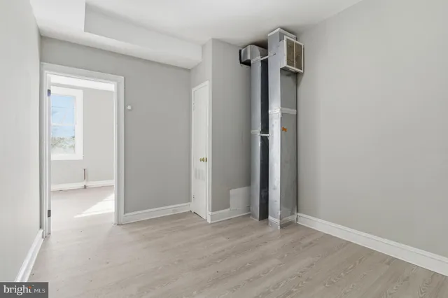 an empty room with closet and a bathroom