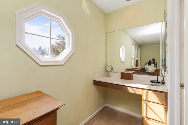 a view of walk in closet with clothes