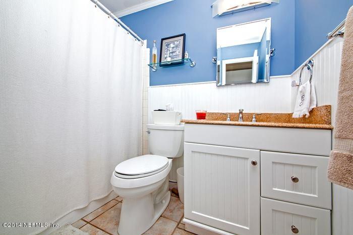 3345 Eunice Road Jacksonville, FL 32250 - Photo 14 of 21 a bathroom with a toilet sink vanity and mirror