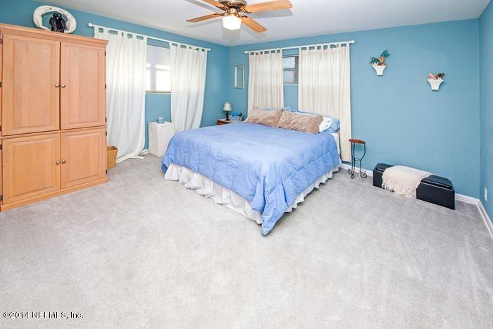 3345 Eunice Road Jacksonville, FL 32250 - Photo 16 of 21 a bedroom with a bed dresser and a window