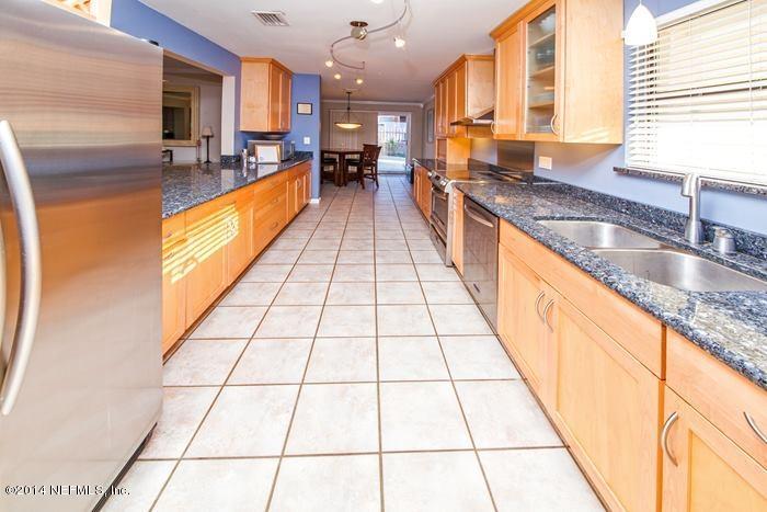 3345 Eunice Road Jacksonville, FL 32250 - Photo 3 of 21 a large kitchen with granite countertop a large counter top and a stove
