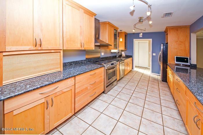 3345 Eunice Road Jacksonville, FL 32250 - Photo 4 of 21 a large kitchen with stainless steel appliances granite countertop a sink and cabinets
