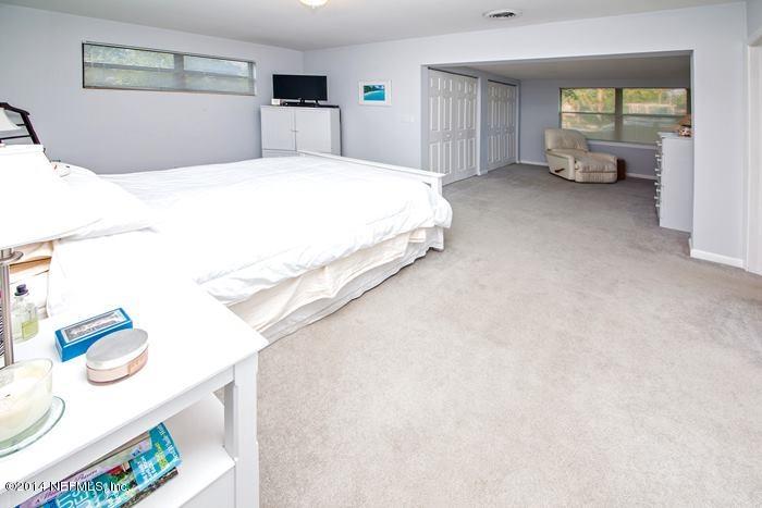 3345 Eunice Road Jacksonville, FL 32250 - Photo 6 of 21 a spacious bedroom with a bed and dresser