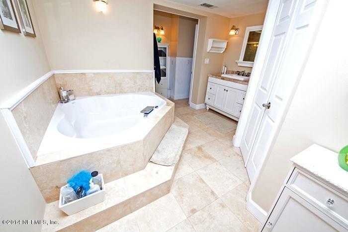 3345 Eunice Road Jacksonville, FL 32250 - Photo 7 of 21 a bathroom with a tub sink and mirror