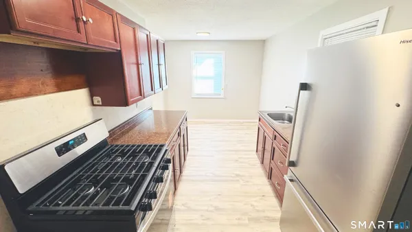 a view of an entryway with wooden floor