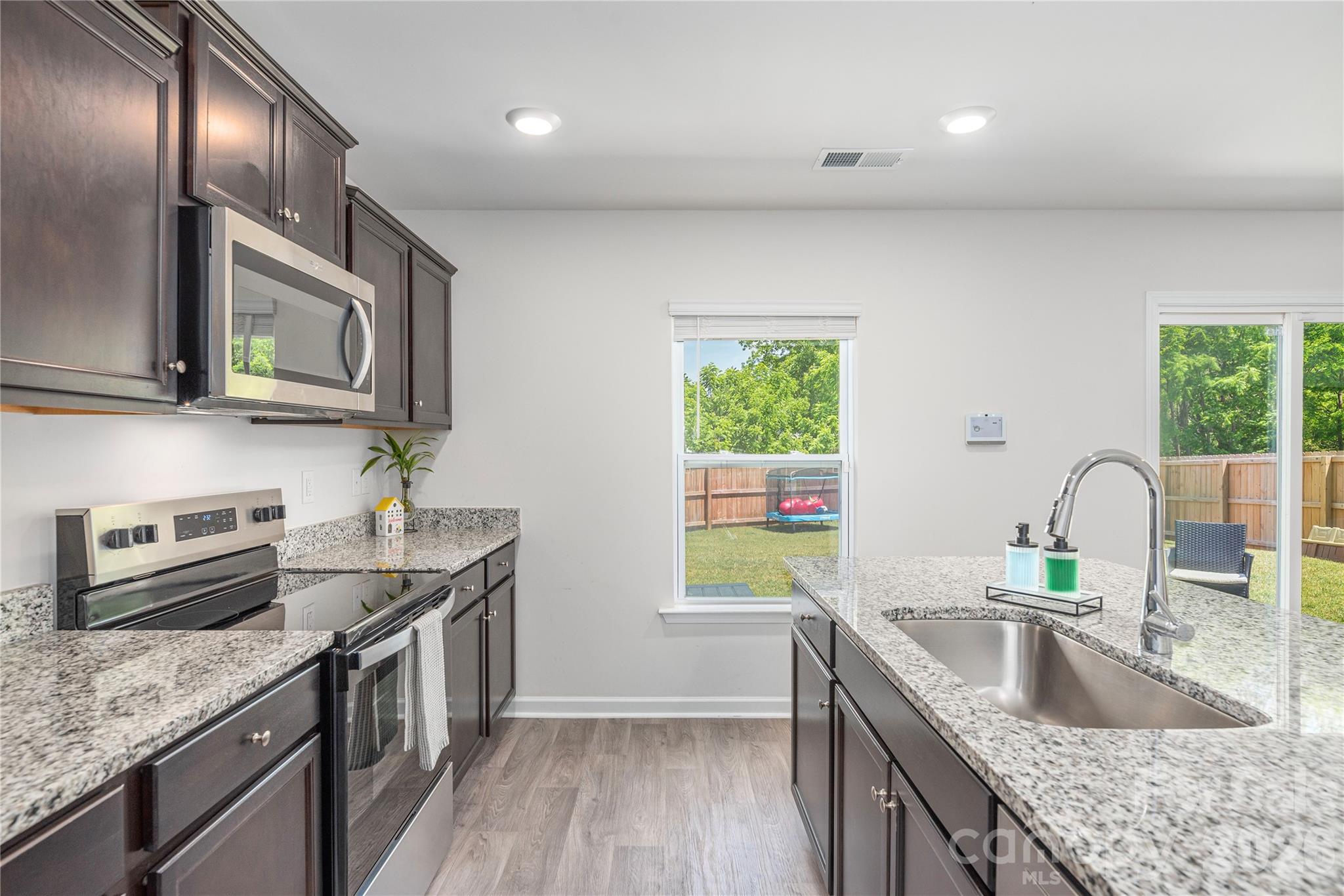 8 Madelyn Drive Clyde, NC 28721 - Photo 14 of 43 a kitchen with stainless steel appliances granite countertop a sink stove and cabinets