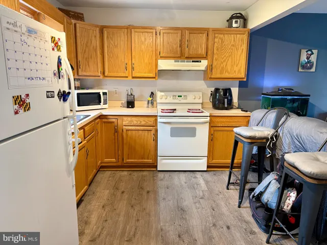 a kitchen with stainless steel appliances a stove a sink and a refrigerator