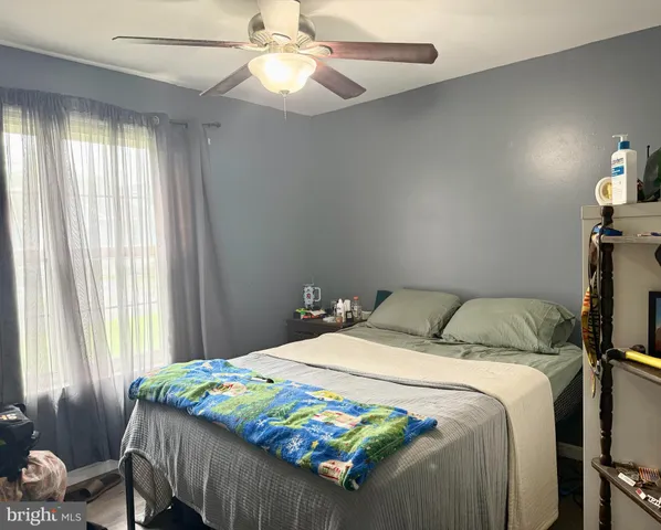 a bedroom with a bed and window