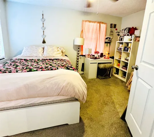 a bed sitting in a room next to a window