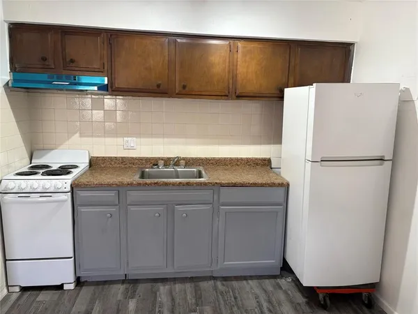 a kitchen with a sink and a refrigerator
