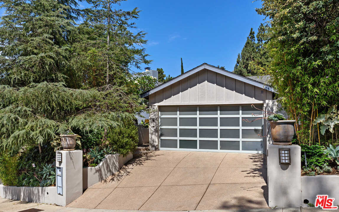 8027 Briar Summit Drive Los Angeles, CA 90046 - Photo 2 of 43 a front view of a house with a yard