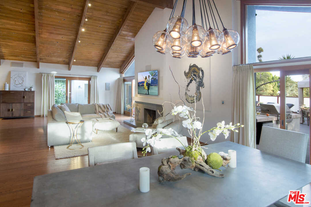 8027 Briar Summit Drive Los Angeles, CA 90046 - Photo 13 of 43 a living room with fireplace furniture and a chandelier