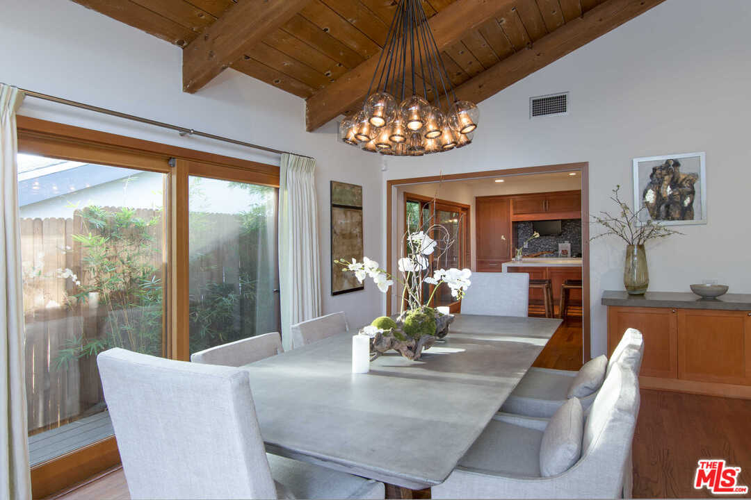 8027 Briar Summit Drive Los Angeles, CA 90046 - Photo 14 of 43 a view of a dining room with furniture wooden floor and chandelier