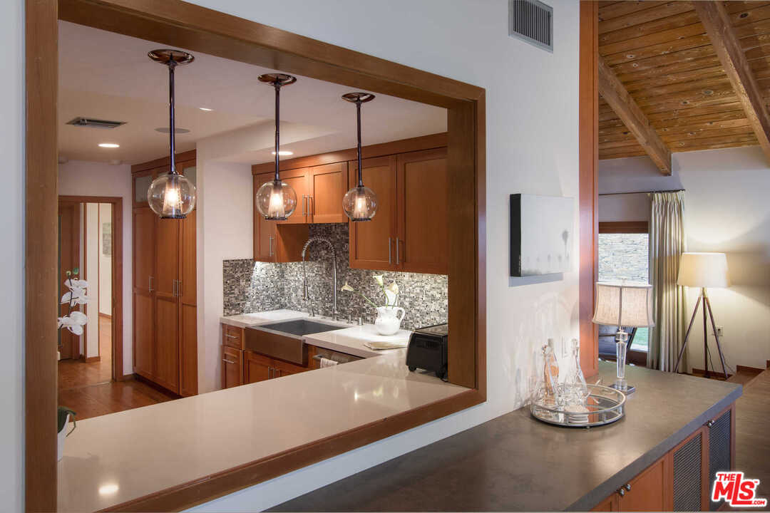 8027 Briar Summit Drive Los Angeles, CA 90046 - Photo 15 of 43 a large kitchen with a large counter top appliances and cabinets