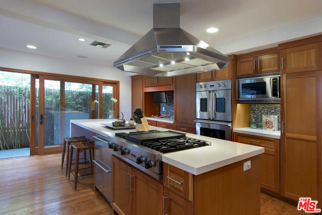 8027 Briar Summit Drive Los Angeles, CA 90046 - Photo 17 of 43 a kitchen that has a stove and a view of living room