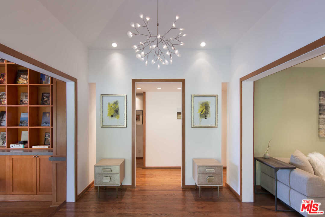 8027 Briar Summit Drive Los Angeles, CA 90046 - Photo 22 of 43 a view of a hallway with wooden floor and windows