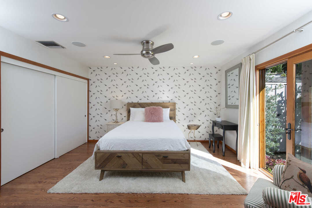 8027 Briar Summit Drive Los Angeles, CA 90046 - Photo 26 of 43 a bedroom with a bed and wooden floor