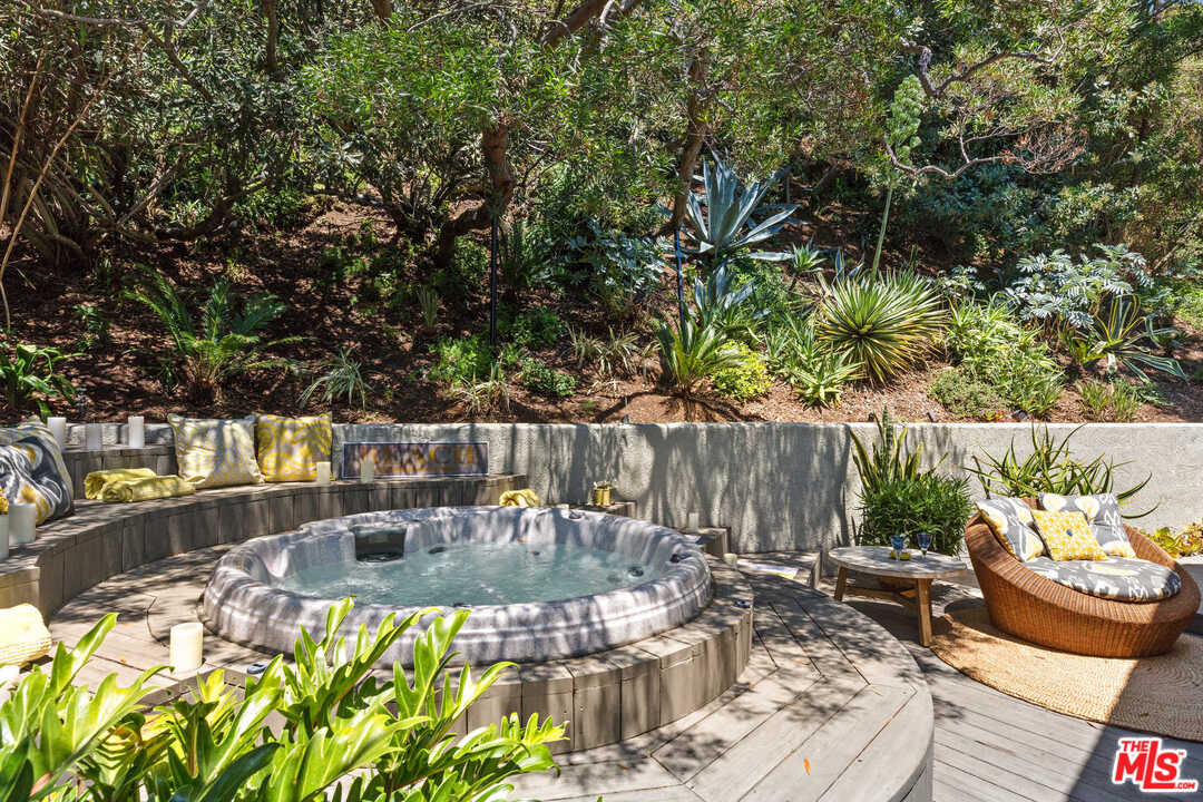 8027 Briar Summit Drive Los Angeles, CA 90046 - Photo 31 of 43 a view of a patio with table and chairs potted plants and large tree