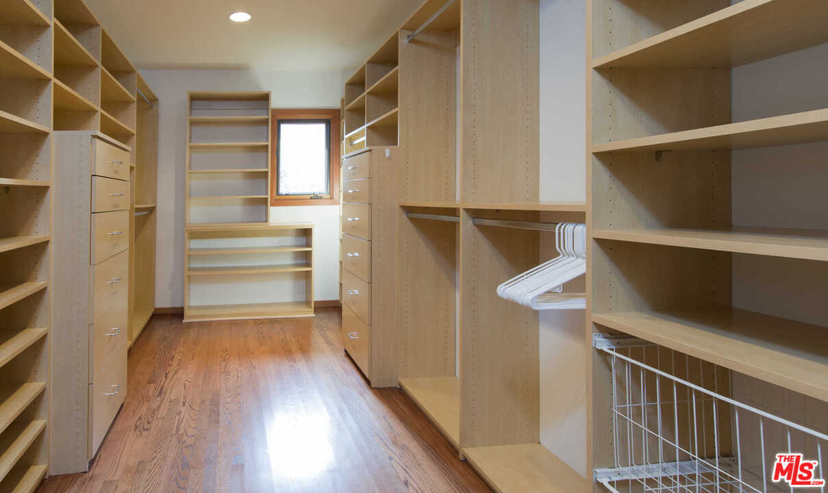 8027 Briar Summit Drive Los Angeles, CA 90046 - Photo 34 of 43 a view of walk in closet with wooden floor and stairs