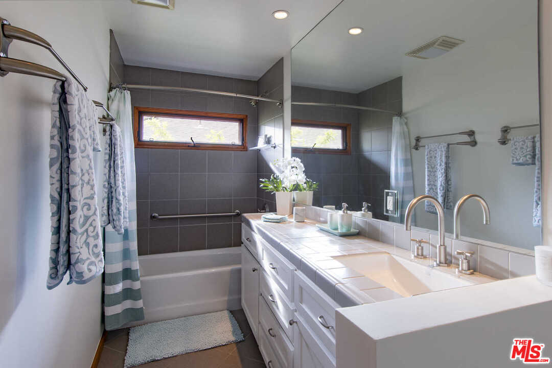 8027 Briar Summit Drive Los Angeles, CA 90046 - Photo 36 of 43 a bathroom with a double vanity sink mirror and shower