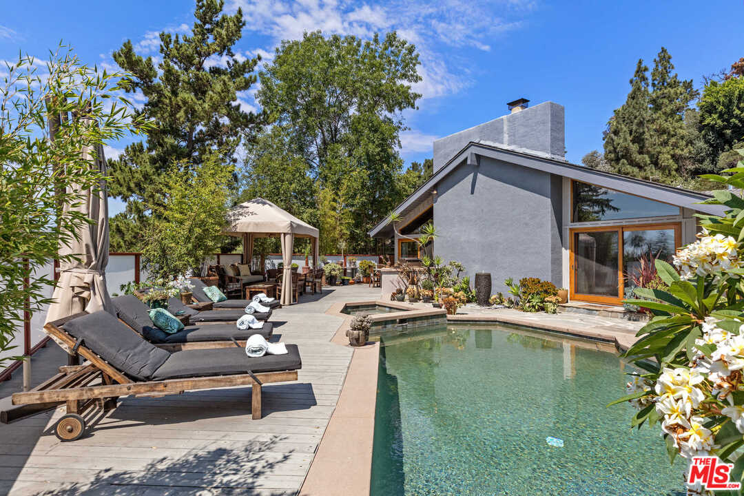 8027 Briar Summit Drive Los Angeles, CA 90046 - Photo 42 of 43 a view of a patio with table and chairs potted plants with wooden fence