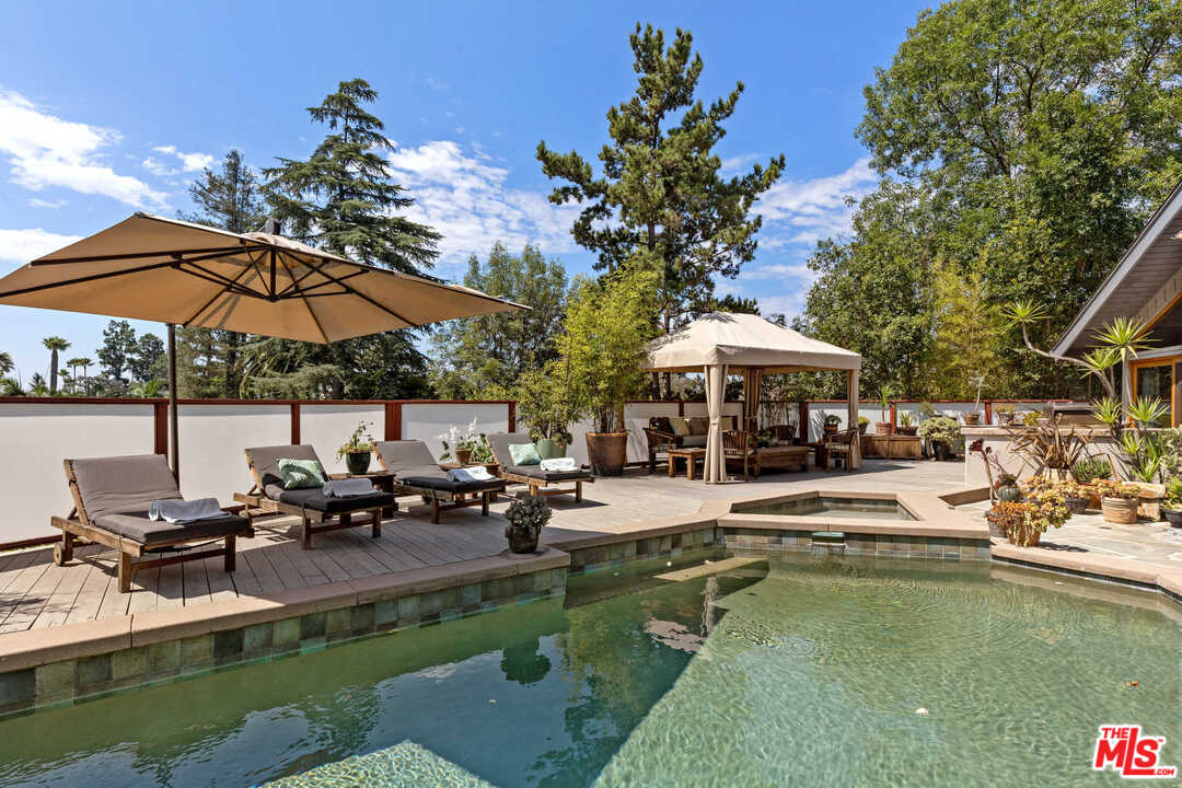 8027 Briar Summit Drive Los Angeles, CA 90046 - Photo 7 of 43 a view of a swimming pool with lounge chairs in patio