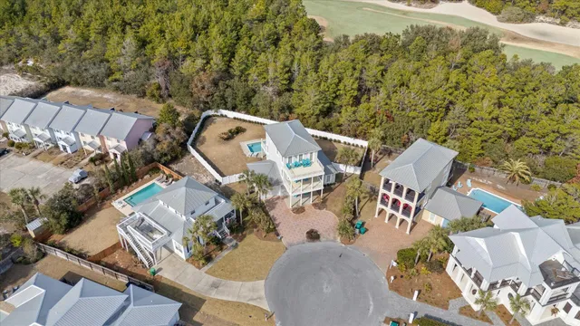 a kitchen with stainless steel appliances kitchen island granite countertop a refrigerator a stove a dining table and chairs